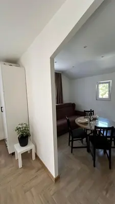 a living room with a table and a couch at Apartmani Radmanovic in Tivat