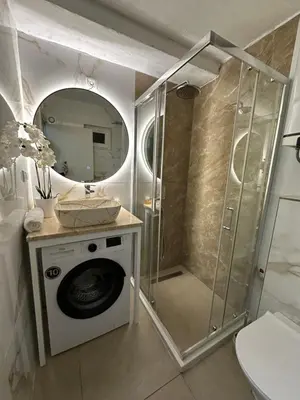 a bathroom with a shower and a washing machine at Apartman Budva Centar in Budva
