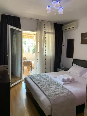 a bedroom with a bed with two towels on it at Apartman Budva Centar in Budva