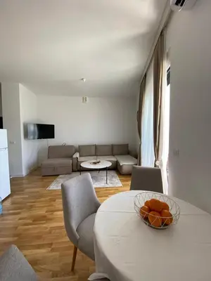 a living room with a table with a bowl of oranges on it at Al Mare in Ulcinj