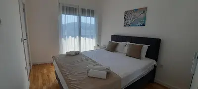a bedroom with a large bed with two towels on it at Al Mare in Ulcinj