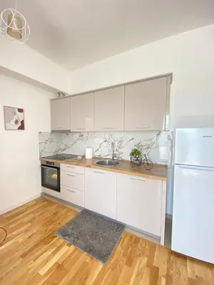a kitchen with white cabinets and a white refrigerator at Al Mare in Ulcinj