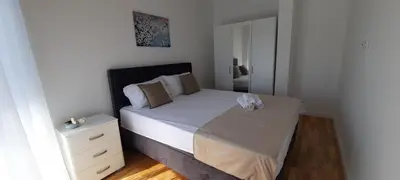 a small bedroom with a bed and a dresser at Al Mare in Ulcinj