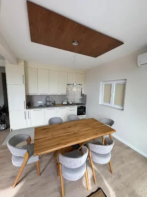 a kitchen with a wooden table and some chairs at Montesea Villa in Gornji Sušanj