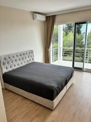 a bedroom with a bed and a large window at Montesea Villa in Gornji Sušanj