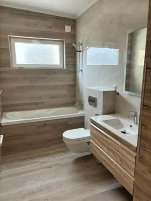 a bathroom with a toilet and a tub and a sink at Montesea Villa in Gornji Sušanj