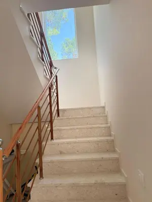 a staircase in a house with a picture on the wall at Montesea Villa in Gornji Sušanj