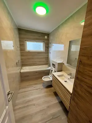 a bathroom with a tub and a toilet and a sink at Montesea Villa in Gornji Sušanj