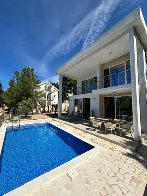 a villa with a swimming pool in front of a house at Montesea Villa in Gornji Sušanj
