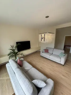 a living room with two couches and a flat screen tv at Montesea Villa in Gornji Sušanj