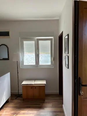 a room with a table and two windows in it at Studio Nik in Cetinje