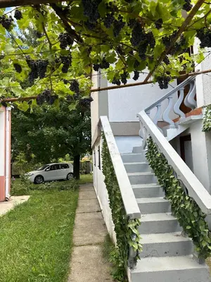 a stairway leading up to a building with a car at Studio Nik in Cetinje