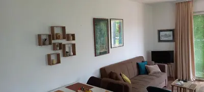 a living room with a couch and some pictures on the wall at Studio Nik in Cetinje