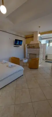 a bedroom with a bed and a fireplace at Vaso & Viktor Apartment in Kotor