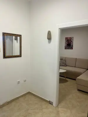 a living room with a mirror and a couch at Apartman Vučko in Rafailovici