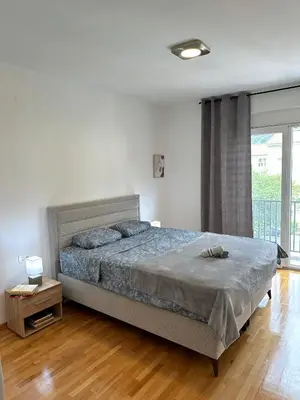a bedroom with a bed and a large window at Nonna Marija in Kotor