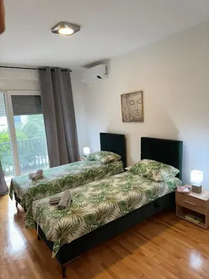 a bedroom with two beds and a window at Nonna Marija in Kotor