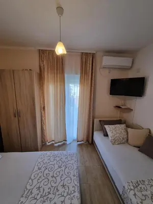 a bedroom with a bed and a flat screen tv at DMD Apartments in Budva
