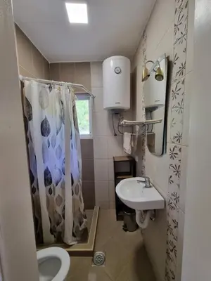 a bathroom with a sink and a shower curtain at DMD Apartments in Budva