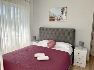 a bedroom with a large bed with two towels on it at Era Apartments in Ulcinj