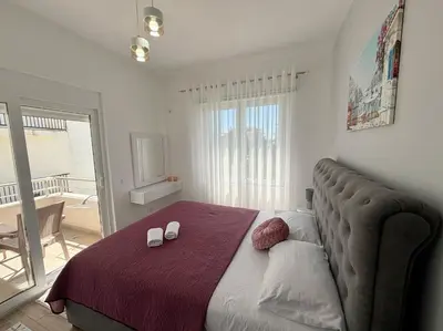 a bedroom with a bed with two shoes on it at Era Apartments in Ulcinj
