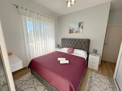 a bedroom with a bed with two towels on it at Era Apartments in Ulcinj