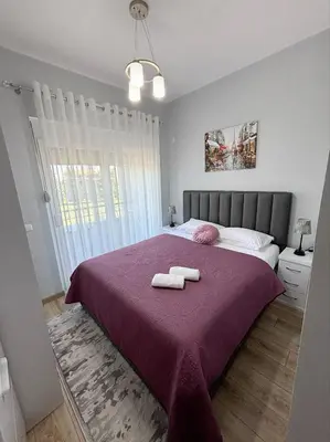 a bedroom with a bed with two towels on it at Era Apartments in Ulcinj