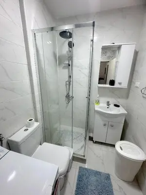 a bathroom with a shower and a toilet and a sink at Era Apartments in Ulcinj