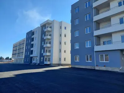two tall apartment buildings in a parking lot at Era Apartments in Ulcinj