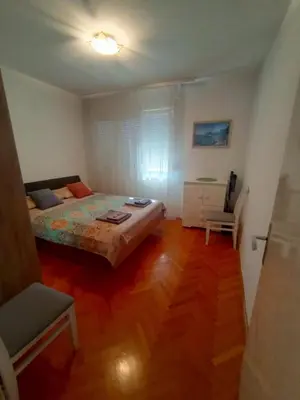 a bedroom with a bed and a chair in it at Lamela in Bar