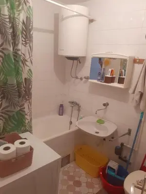 a bathroom with a sink and a shower curtain at Lamela in Bar