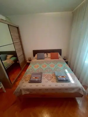 a bedroom with a bed and a large mirror at Lamela in Bar