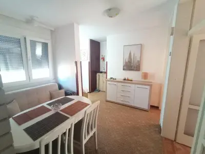 a living room with a dining table and a kitchen at Lamela in Bar