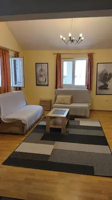 a bedroom with a bed and a couch and a table at Engie Apartment in Budva