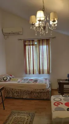 a bedroom with a bed and a chandelier at Engie Apartment in Budva