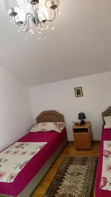 a bedroom with a bed and a chandelier at Engie Apartment in Budva