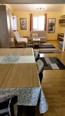a living room with a table and a couch at Engie Apartment in Budva