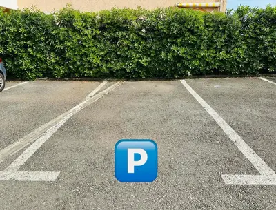 a parking lot with a blue parking sign in it at Serenity Seaview Suite Przno in Pržno