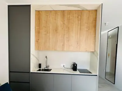 a kitchen with a sink and a wooden cabinet at Serenity Seaview Suite Przno in Pržno