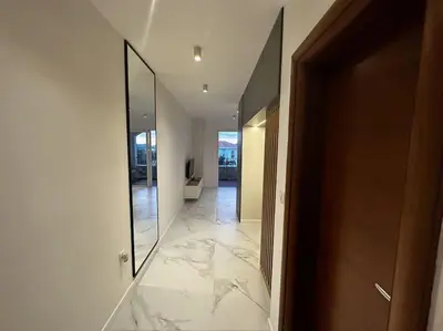 a hallway with a large mirror and a marble floor at Serenity Seaview Suite Przno in Pržno