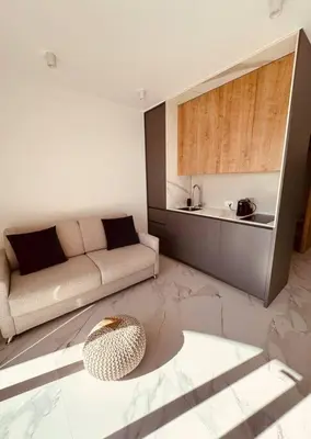 a living room with a couch and a table at Serenity Seaview Suite Przno in Pržno