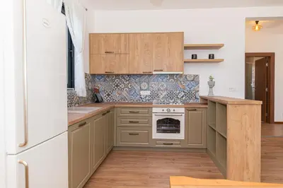 a kitchen with wooden cabinets and a white refrigerator at Country home Dolac POOL&SAUNA in Bar