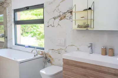 a bathroom with a toilet and a sink and a window at Country home Dolac POOL&SAUNA in Bar