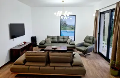 a living room with a couch and a tv at Country home Dolac POOL&SAUNA in Bar