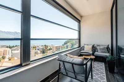 a living room with a view of the ocean at Budva Gate by In Property in Budva