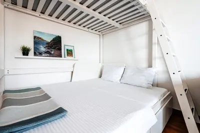 a bedroom with a bunk bed with a ladder at Budva Gate by In Property in Budva