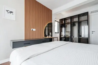 a bedroom with a white bed and a wooden wall at Olive Tree Apartments by In Property in Becici