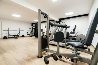 a gym with treadmills and machines in a room at Olive Tree Apartments by In Property in Becici