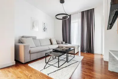 a living room with a couch and a table at Olive Tree Apartments by In Property in Becici
