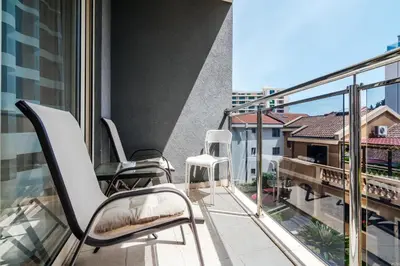 a balcony with chairs and a view of a building at Central studio by In Property in Budva